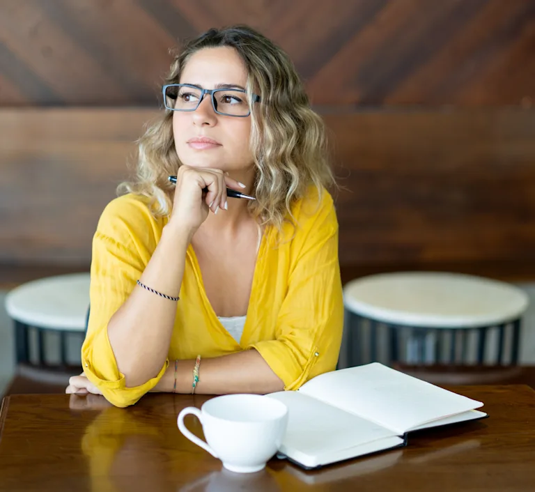 Woman thinking about her marriage, taking notes on things that she wants to try.