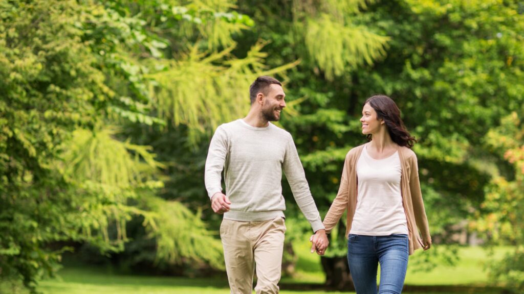 couple holding hands while taking a walk 1